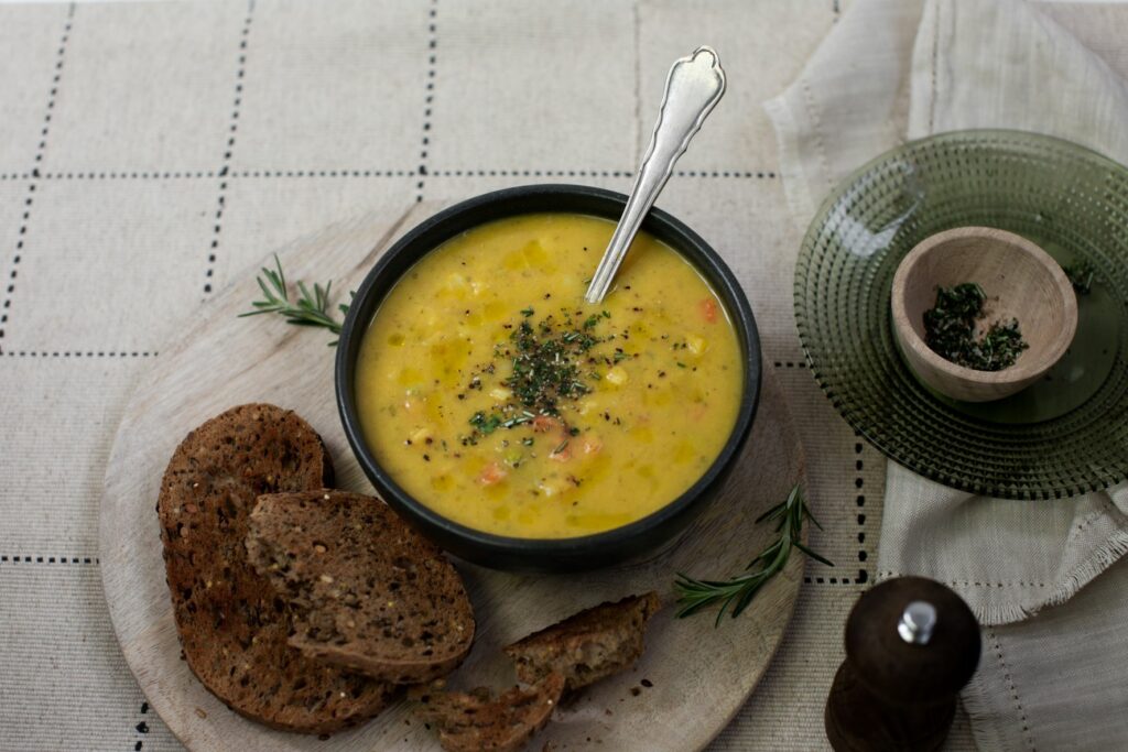 Tideford Organics Country Vegetable Soup in a bowl with brown toast 