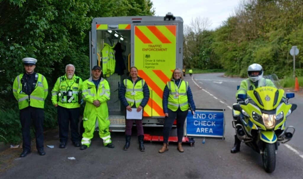 Police and Trading Standards Officers in hi-viz jackets at a roadside checkpoint